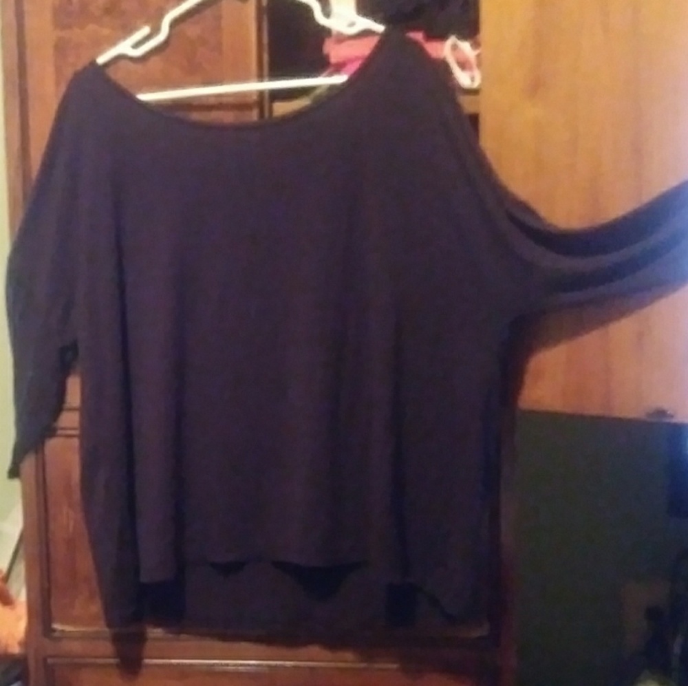 An off the shoulder black dress shirt